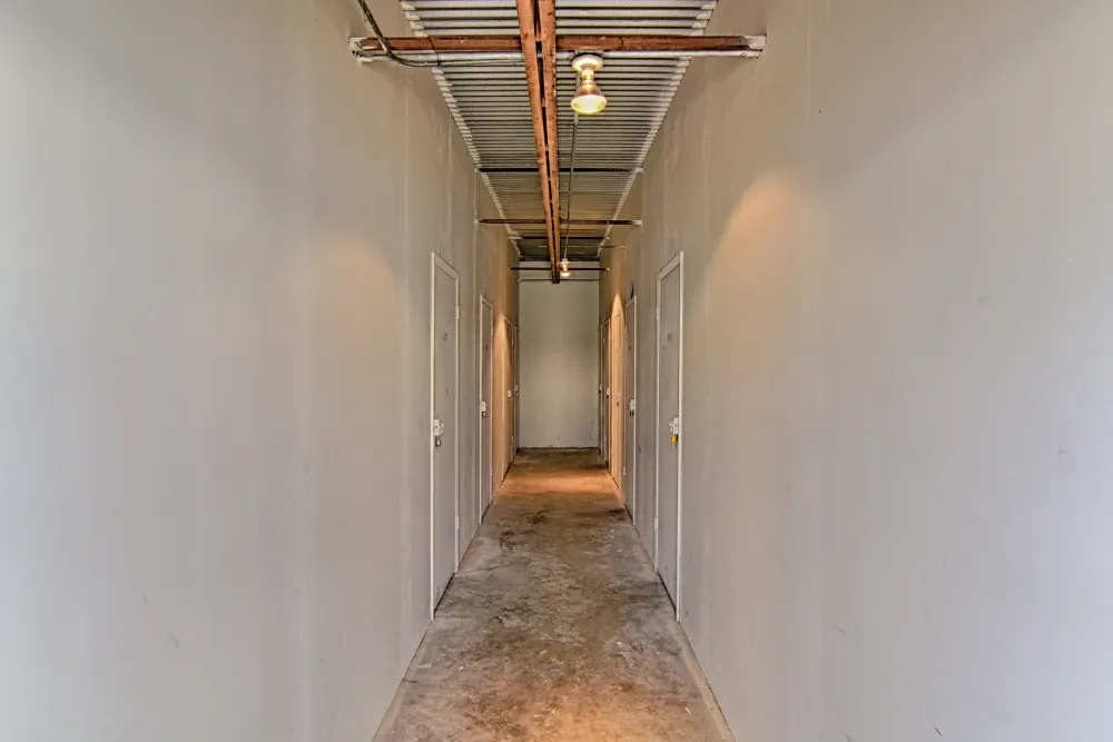 Indoor, non-climate-controlled storage hallway at Rummel Creek Mini Storage.