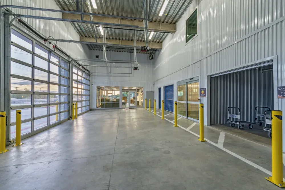 Indoor loading and unloading bay with moving carts at ATX Self Storage.