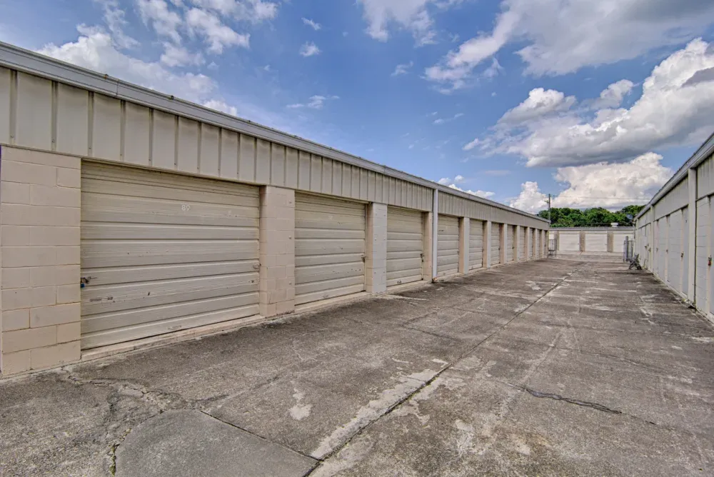 Aisle of outdoor, drive-up storage units at Bay Mini Storage.