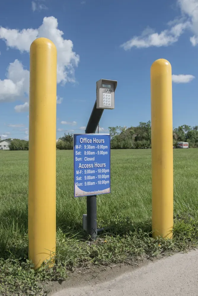 Keypad access and office hours signage at Guardian Self Storage.