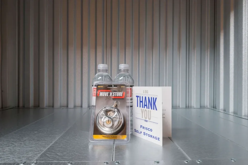 Water bottles and welcome package in storage unit at Frisco Self Storage.
