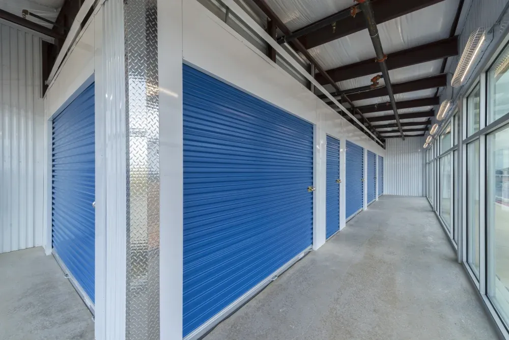 Indoor storage units with blue doors at Westpointe New Braunfels Self Storage.