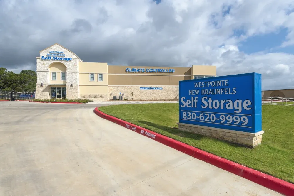 Wide range exterior view of Westpointe New Braunfels Self Storage including signage.