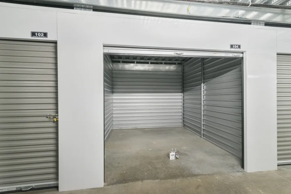 Open climate-controlled storage unit with roll-up door at Southlake Storage.