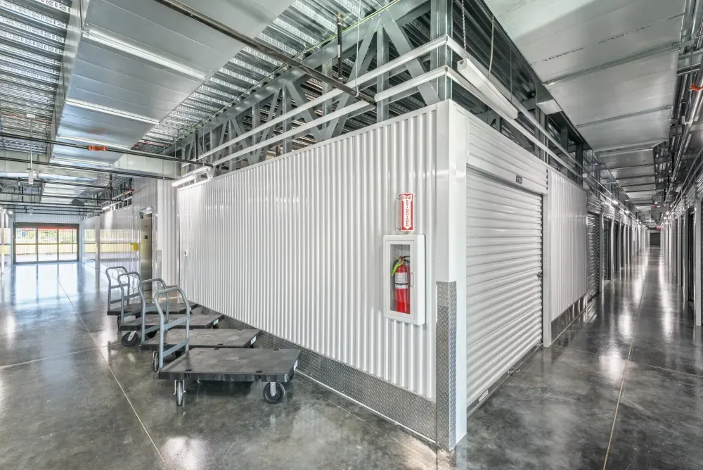 Aisle of climate-controlled storage units and dollies for use at Valley Ranch Storage.