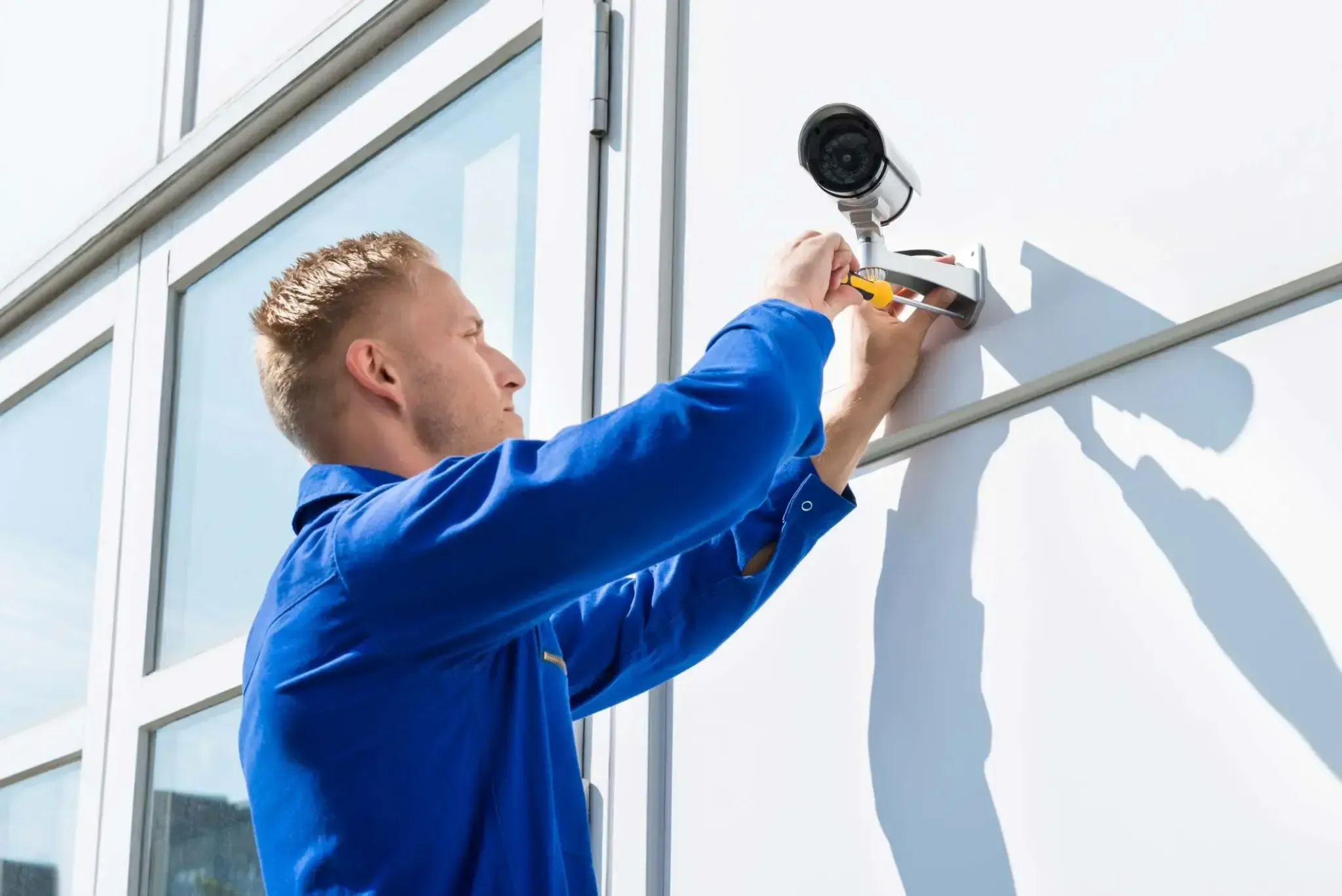 Man installing securtiy camera